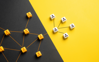 A conceptual illustration of interconnected blocks with person icons, divided between a black and yellow background. The design symbolizes collaboration and the delegation of tasks, representing business process outsourcing and its role in streamlining operations.